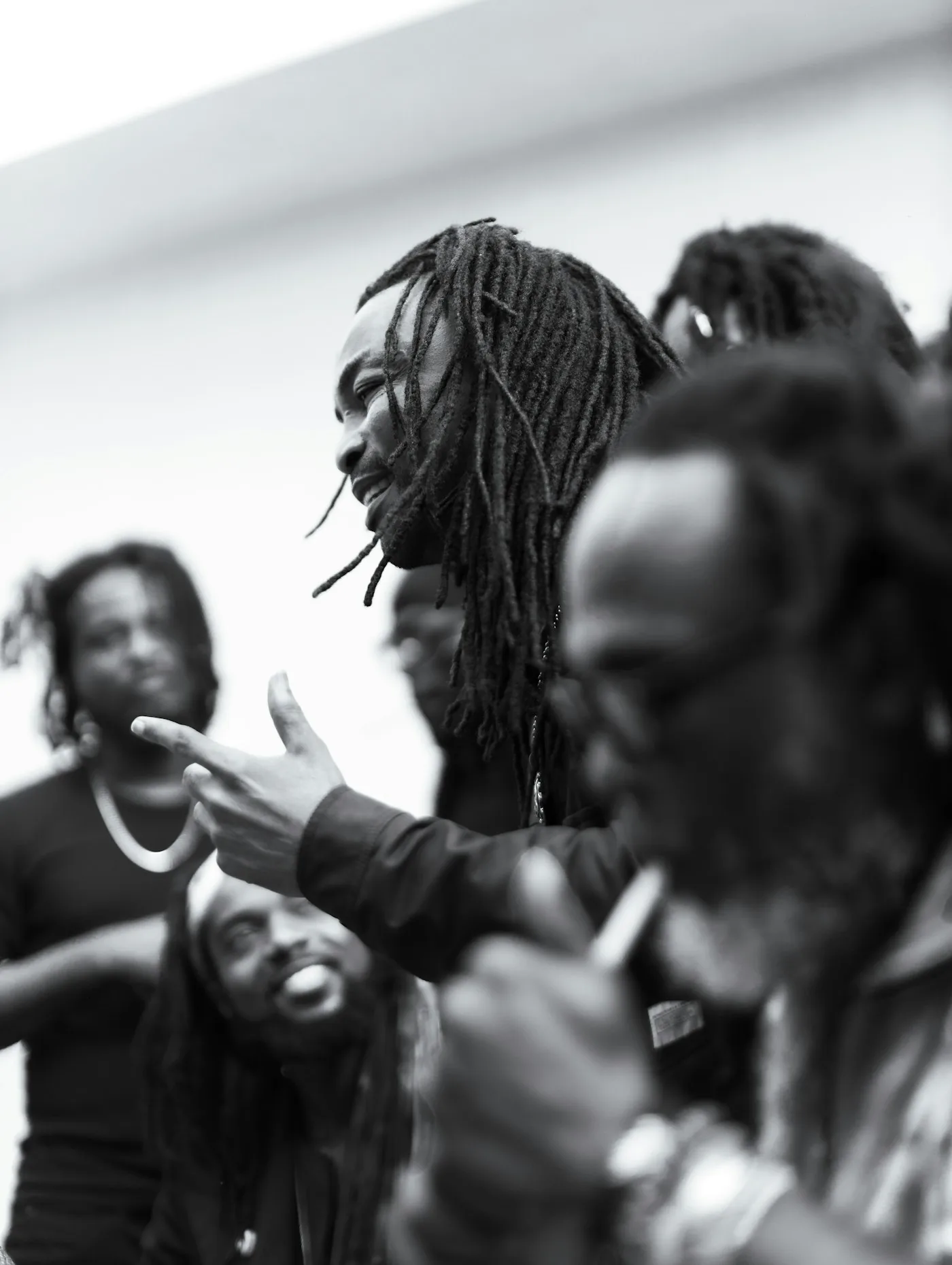 A black and white photograph of young people mid-conversation