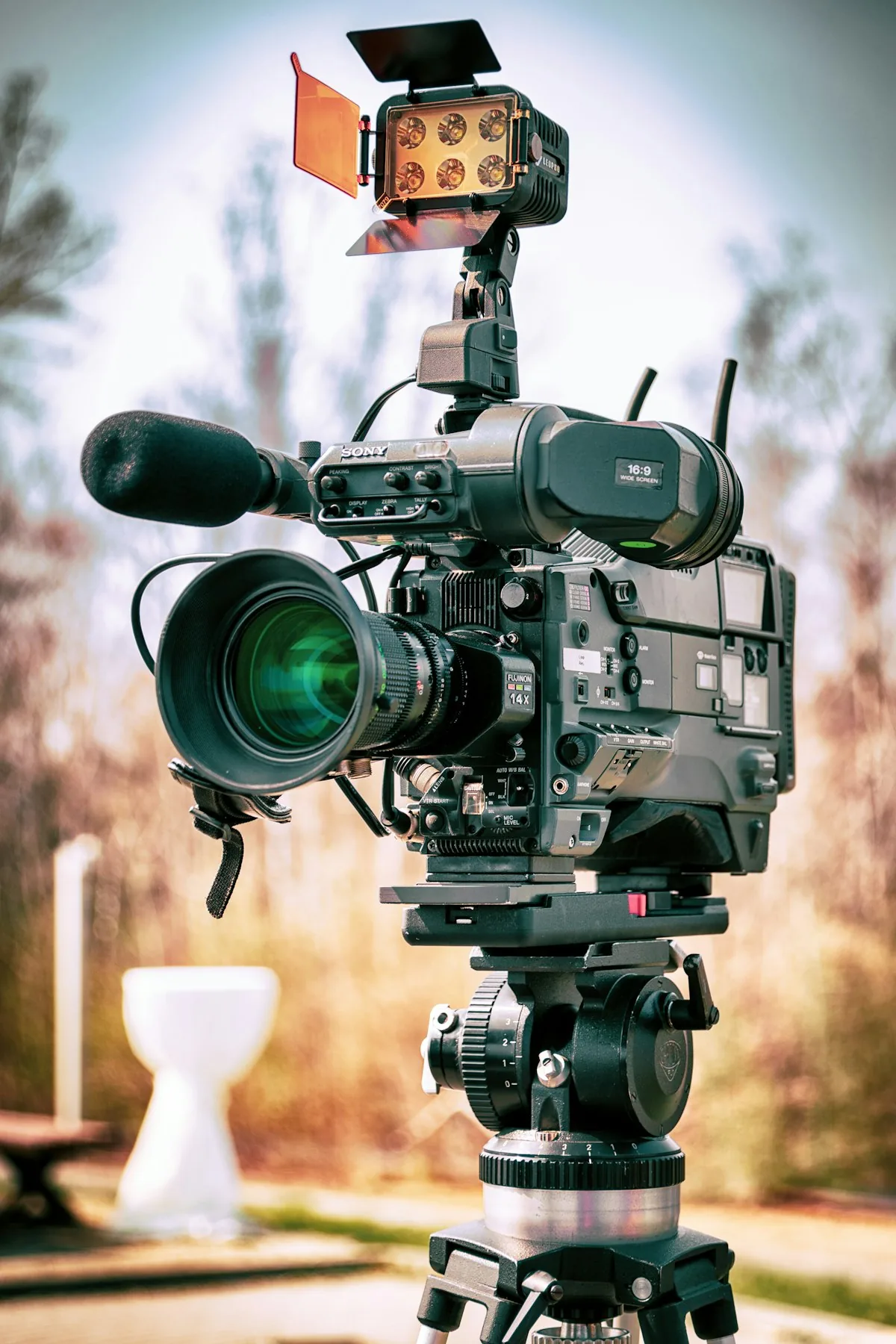 A broadcast camera with a long lens mounted for a shoot