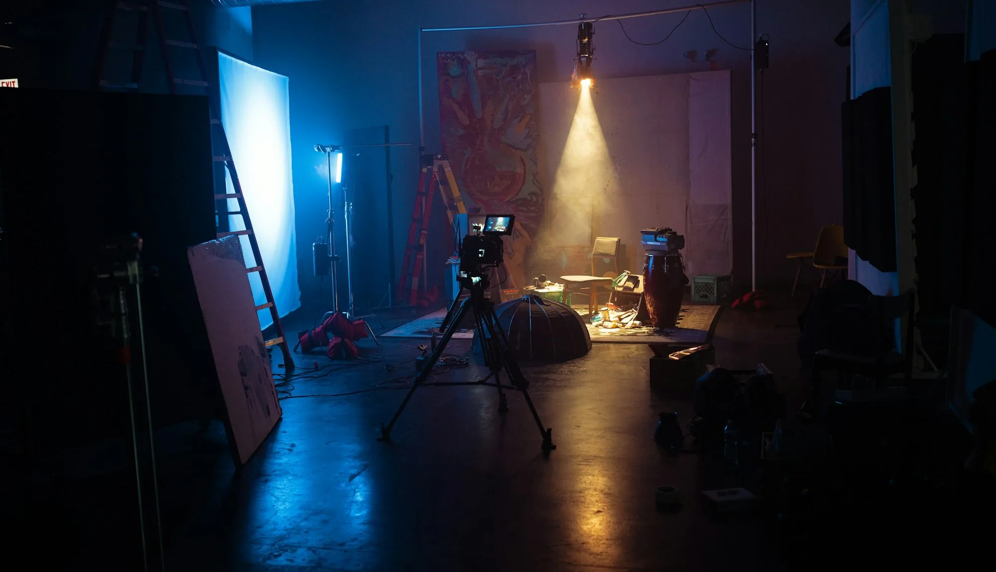 An empty film studio with a single beam of light across the floor